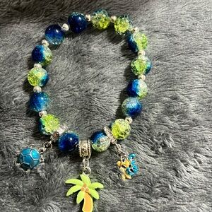 Glass bead bracelet with turtle, coconut tree and mermaid charms
